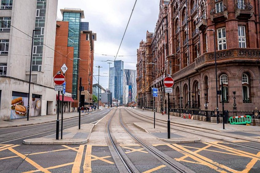 A street with tram tracks, a no entry sign, and a building with a large advertisement. 4