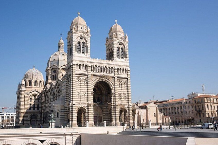 A large, historic cathedral with multiple domes and a prominent clock tower. 2