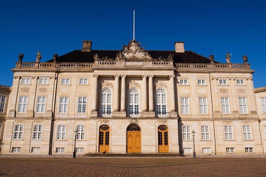 A large, ornate building with a prominent entrance and columns. 2