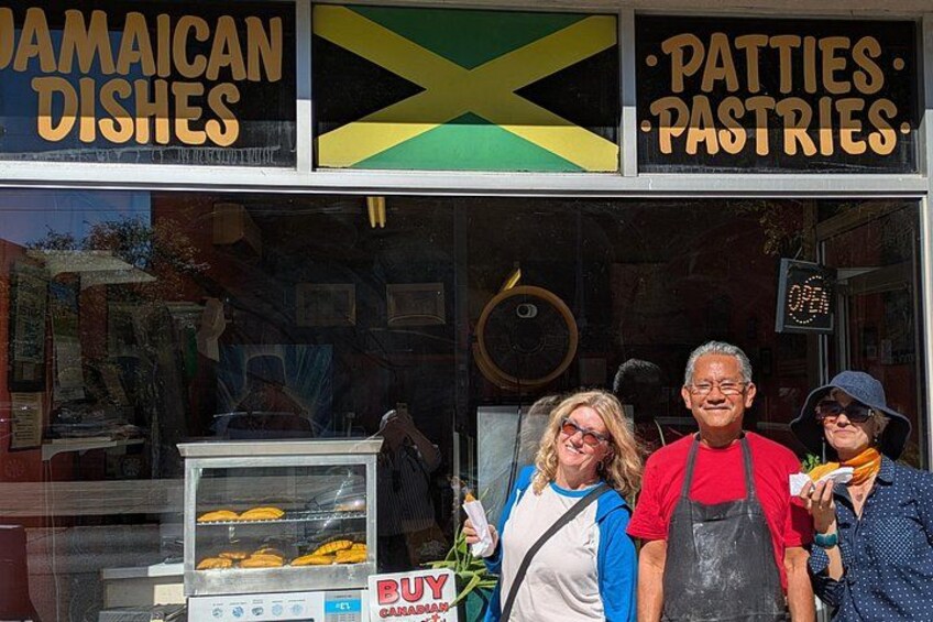 A storefront with signs for 'Jamaican Dishes' and 'Patties & Pastries.' 5