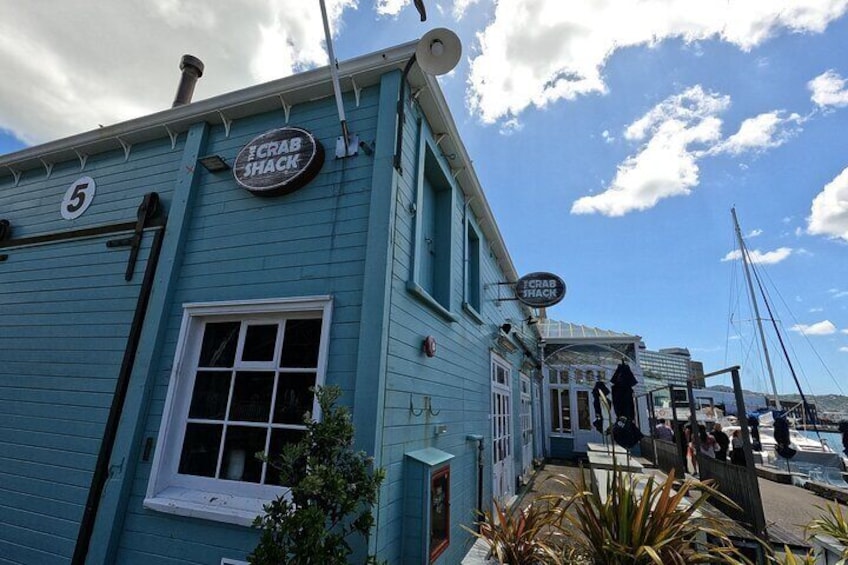 A turquoise building with a 'Crab Shack' sign, a white window, and a number '5' on the side. 4