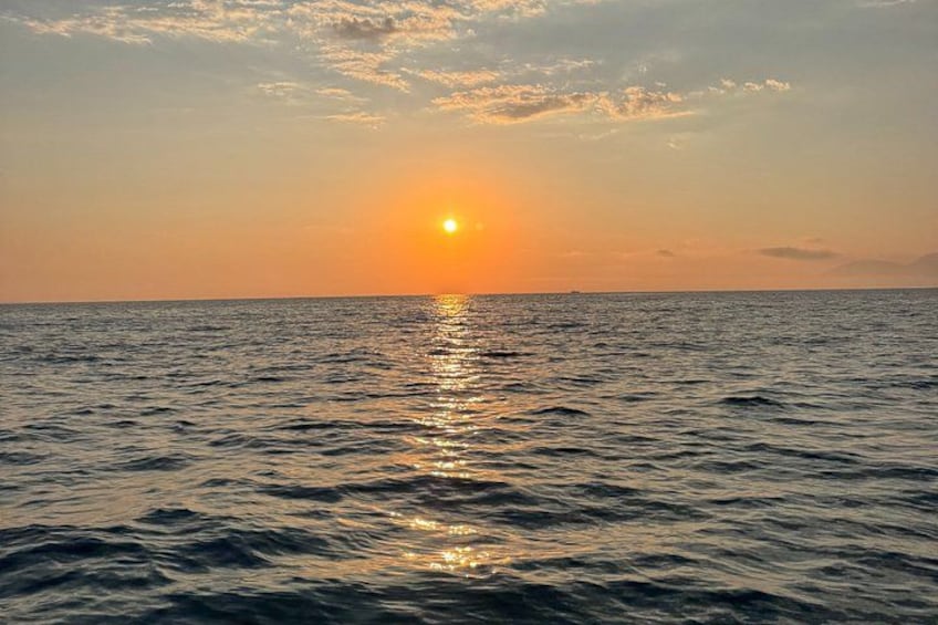 Un coucher de soleil sur l’océan, le soleil se reflétant sur l’eau. 2