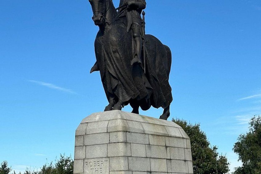 A statue of a man on horseback with a pedestal labeled 'ROBERT THE BRAVE'. 2