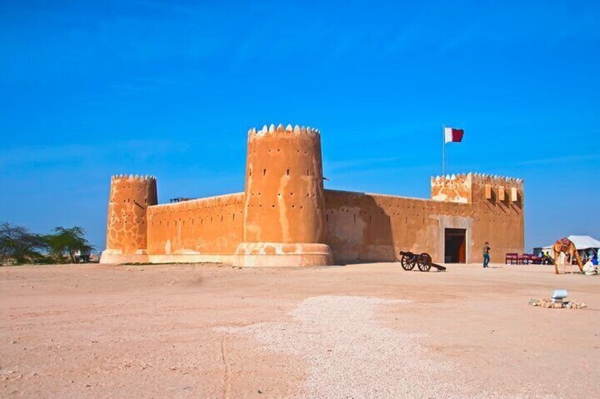 A large, fortified building with a flag, a horse, and a cart in the foreground. 1