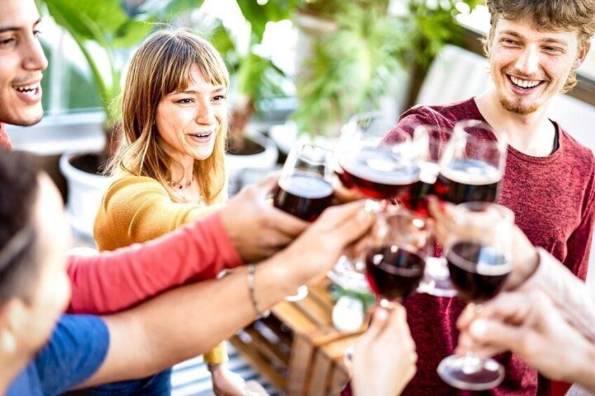 A group of people toasting with wine glasses. 1