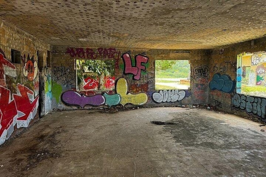 Colorful street art and graffiti bring modern expression to the historic base of the Ruinas del Faro. 1