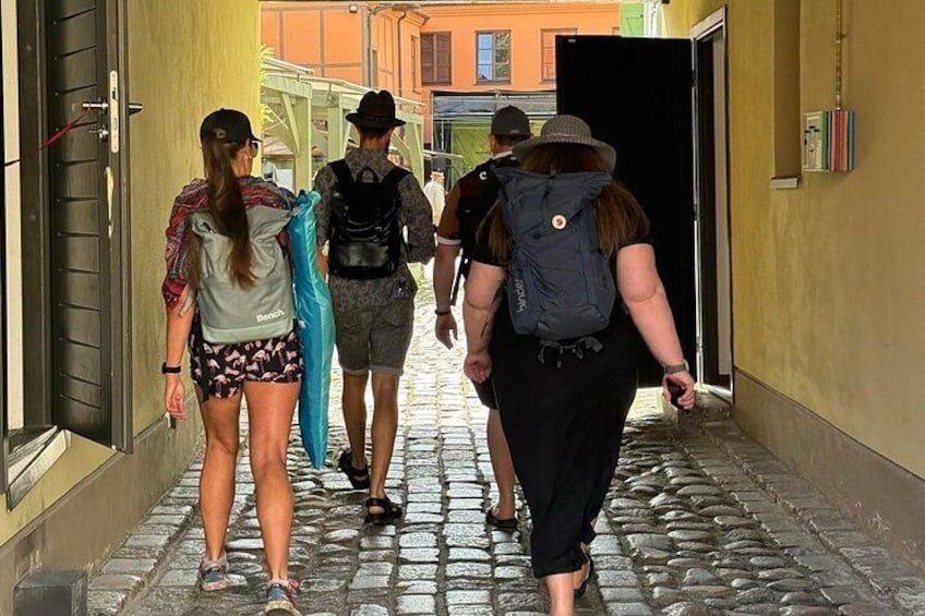 A group of people walking on a cobblestone street. 5