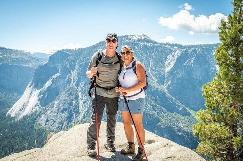 Due persone fanno un'escursione in montagna, con cielo sereno e vista sulla valle. 1