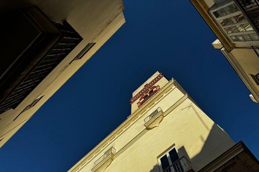 A building with a red sign and a clear blue sky. 2