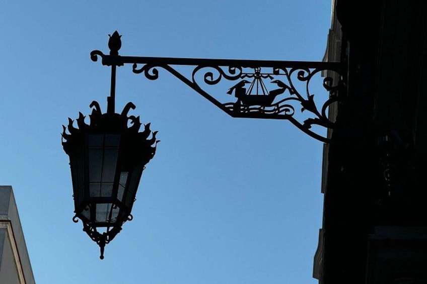A street lamp with ornate metalwork against a clear blue sky. 3
