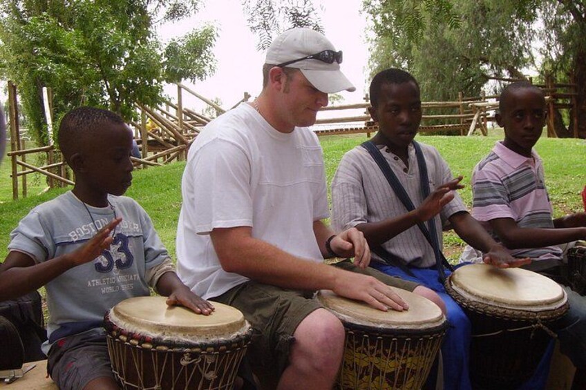 A group of people playing drums outdoors. 3