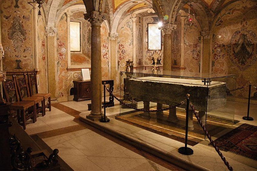 An ornate interior with a central display case, columns, and patterned walls. 5