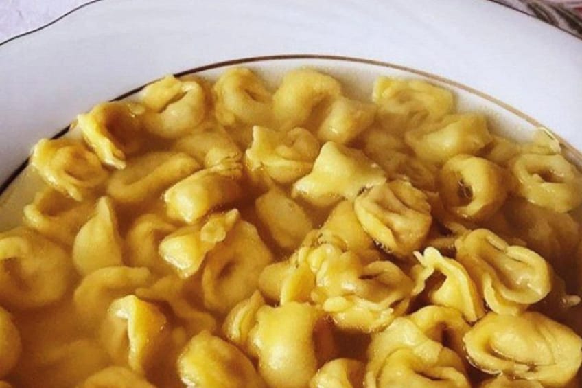 A bowl of pasta with a creamy sauce. 3