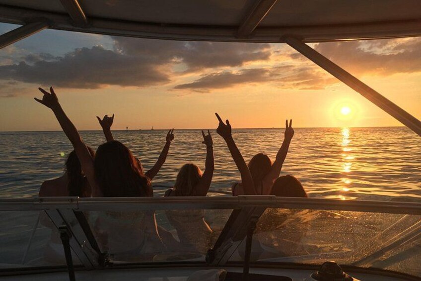 Girls on the bow watching sunset at longboat pass 1