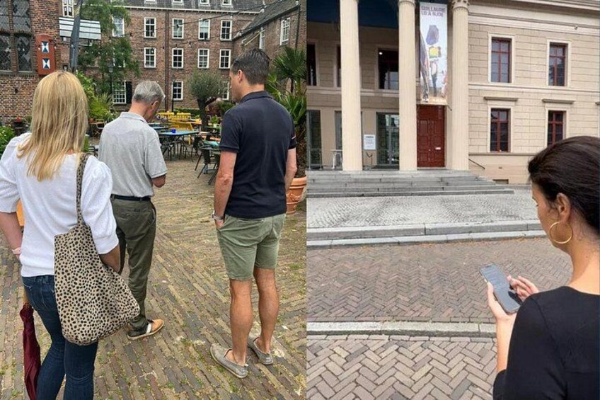 A cobblestone street, a building with columns, and a person using a smartphone. 3