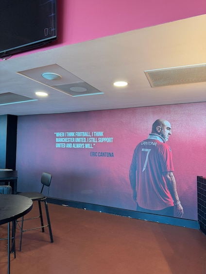 A wall with a quote and a football player. 3