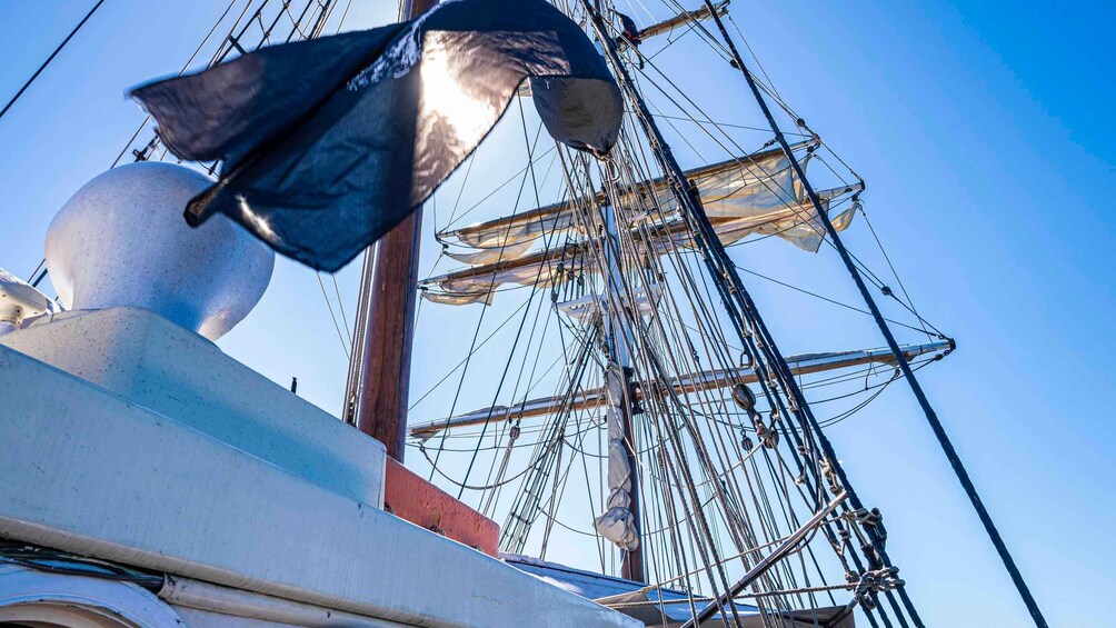 A ship's rigging and sails against a clear sky. 2