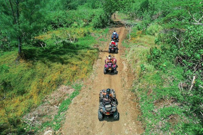 A dirt path with four off-road vehicles. 3
