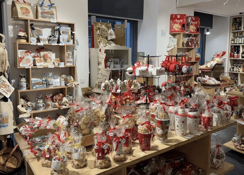 A store with shelves of packaged goods, gift bags, and decorative items. 2