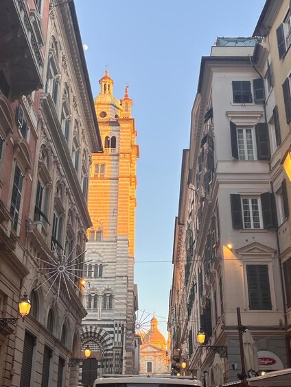 A street with historic buildings, a prominent tower, and a Ferris wheel. 5