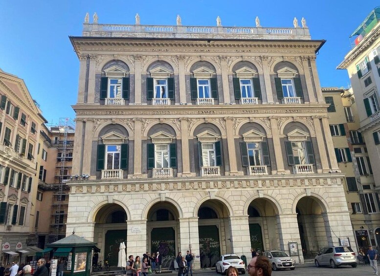 A historic building with arched windows and a central entrance. 2