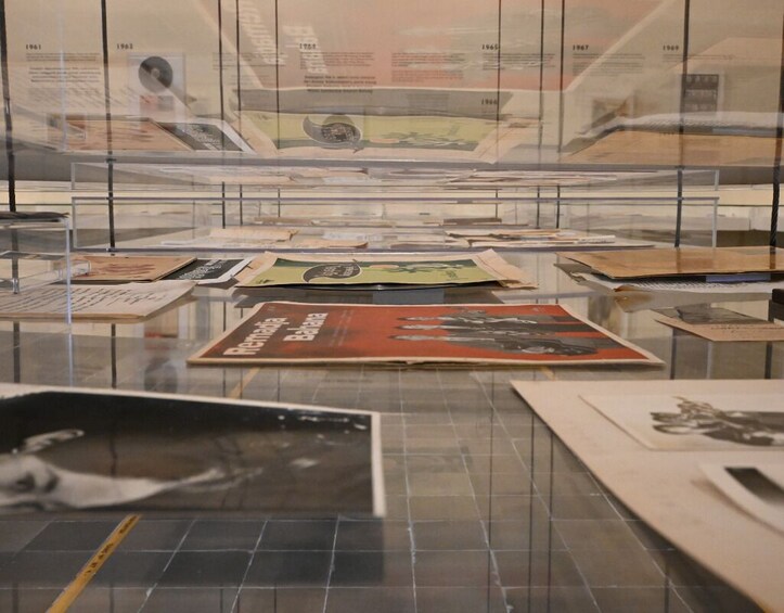 A display of historical documents and photographs in a museum. 3