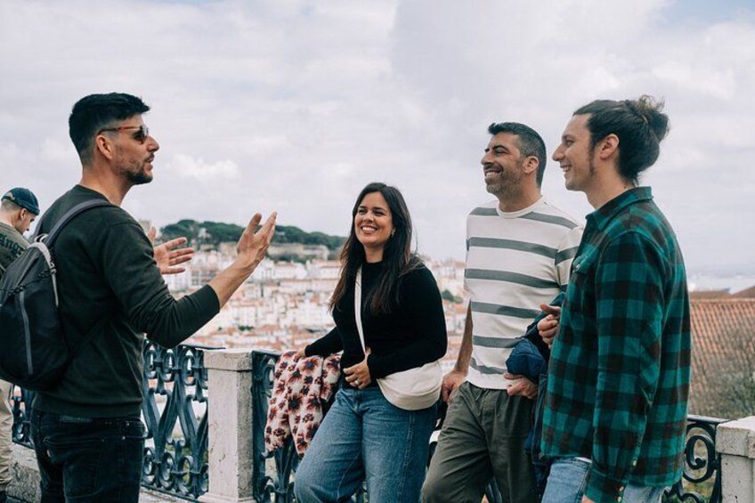 A group of people standing on a rooftop with a cityscape in the background. 3