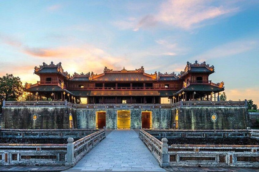 A traditional Chinese building with a symmetrical facade, a central entrance, and a stone pathway leading to it. 1
