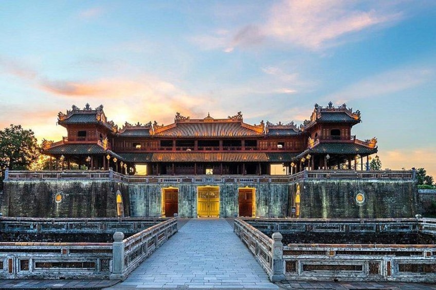 A traditional Chinese building with a central entrance, surrounded by a stone wall and a paved walkway. 1