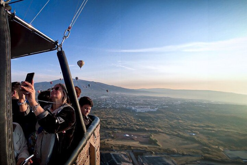A hot air balloon flight with passengers taking photos. 3