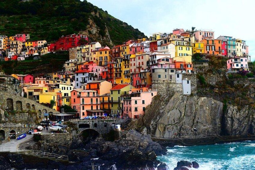 A coastal village with colorful buildings perched on a cliff overlooking the sea. 5