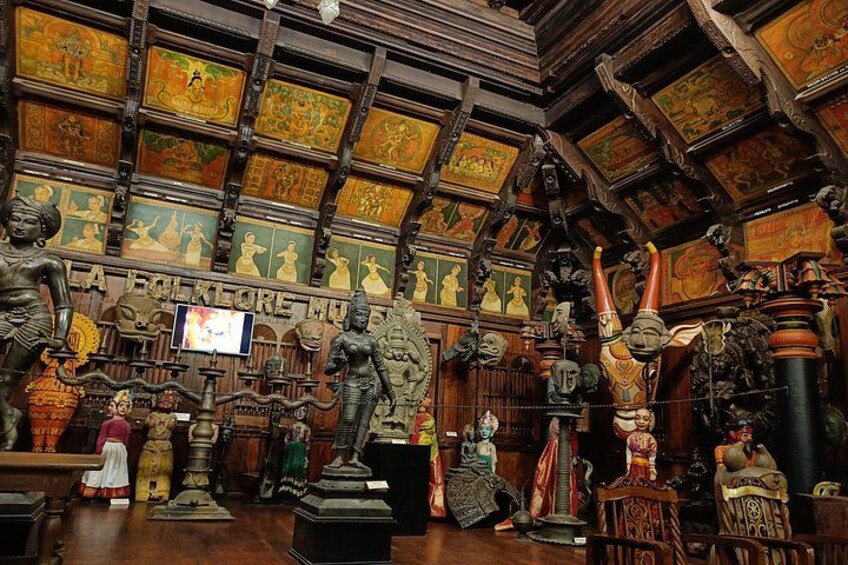 A room filled with various statues and artifacts, including a large Buddha statue and several smaller figures. 2