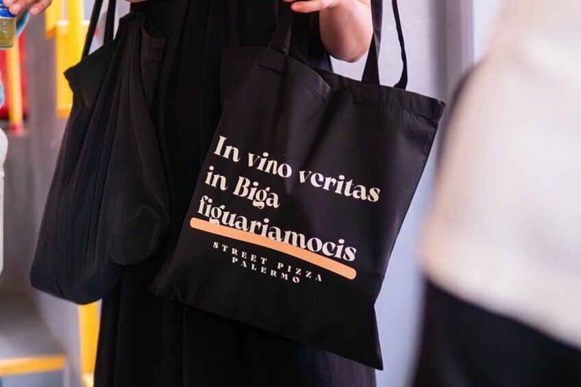 A black tote bag with text on it. 3