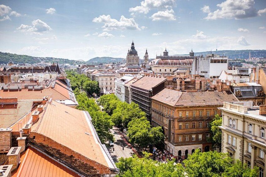 A cityscape with historic buildings, a prominent church, and a river. 2