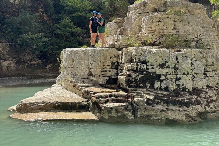 A rocky cliff with a person standing on top. 3