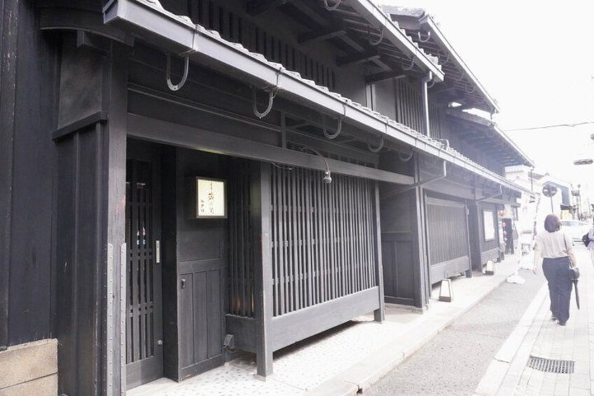 Een traditioneel Japans gebouw met een schuin dak en houten balken. 4