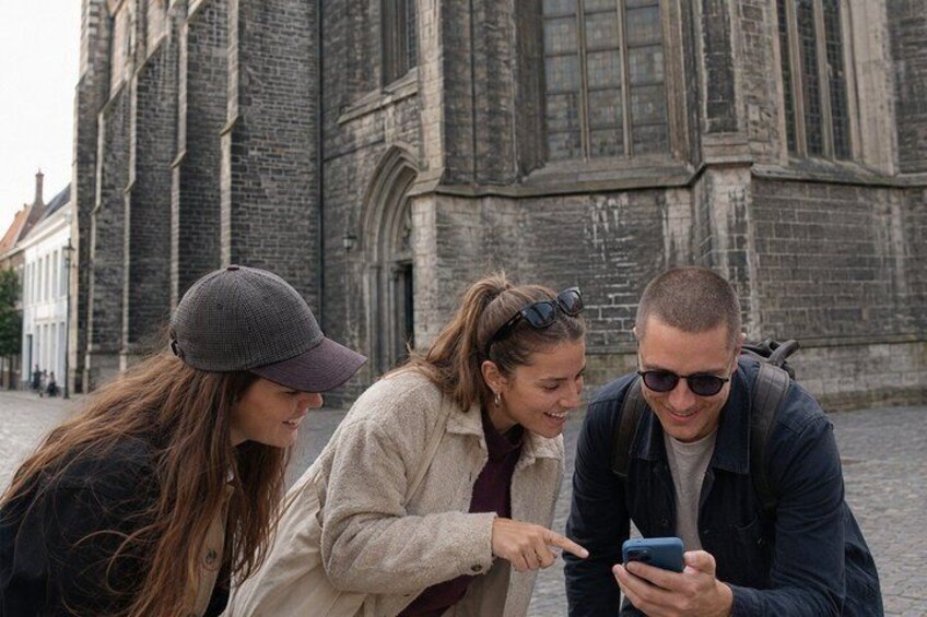 Three people looking at a smartphone. 5
