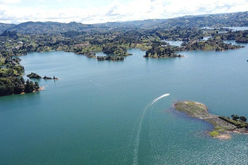 A large lake with several islands, surrounded by hills and trees. 2