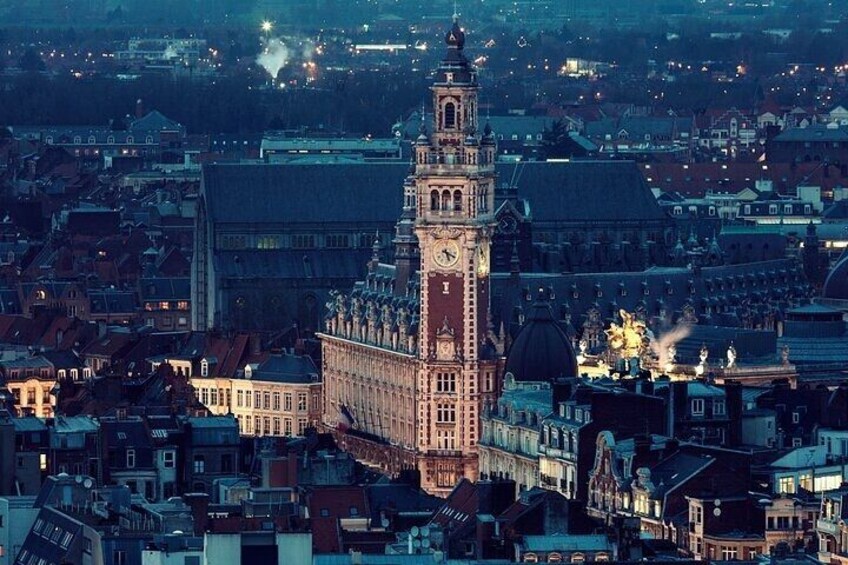 A cityscape with a prominent clock tower, surrounded by historic buildings and a large dome structure. 3