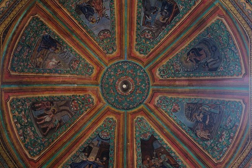 A detailed ceiling with geometric patterns and central circular design. 4