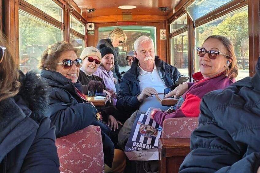 A group of people seated inside a bus, engaged in conversation. 5