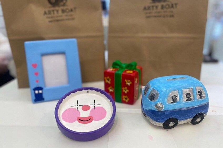 A small blue car, a purple object with a face, and two gift boxes. 2