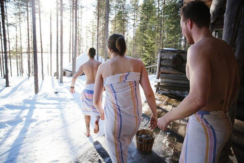 A snowy forest path with people walking. 5