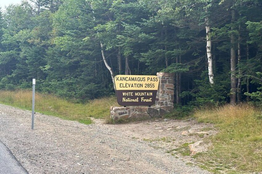 A sign indicating the elevation of Kancamagus Pass at 2855 feet in the White Mountain National Forest. 5