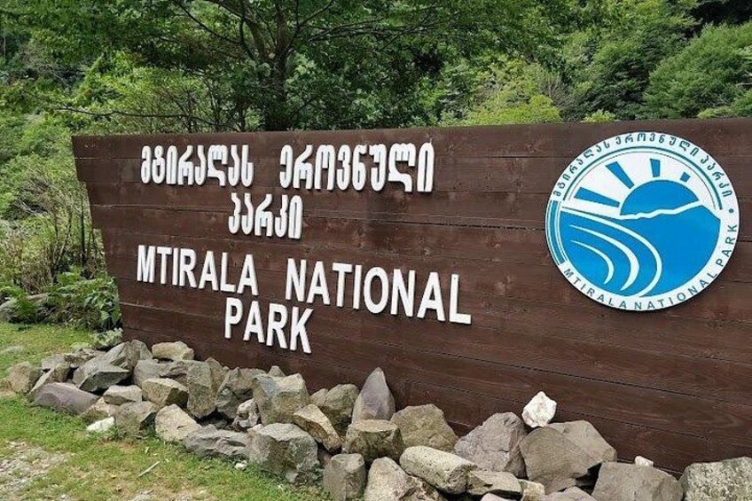 A wooden sign for MTRALA National Park with text and a logo. 5