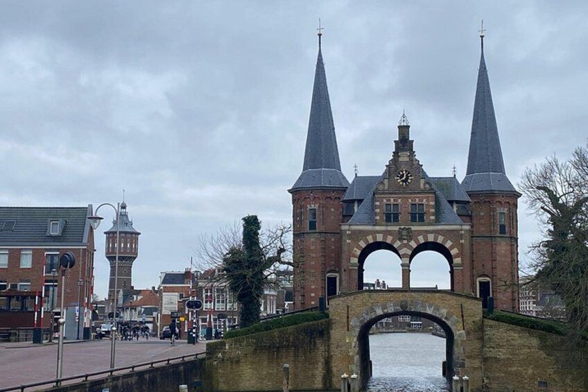 A historic bridge with two towers, a clock, and a river. 5