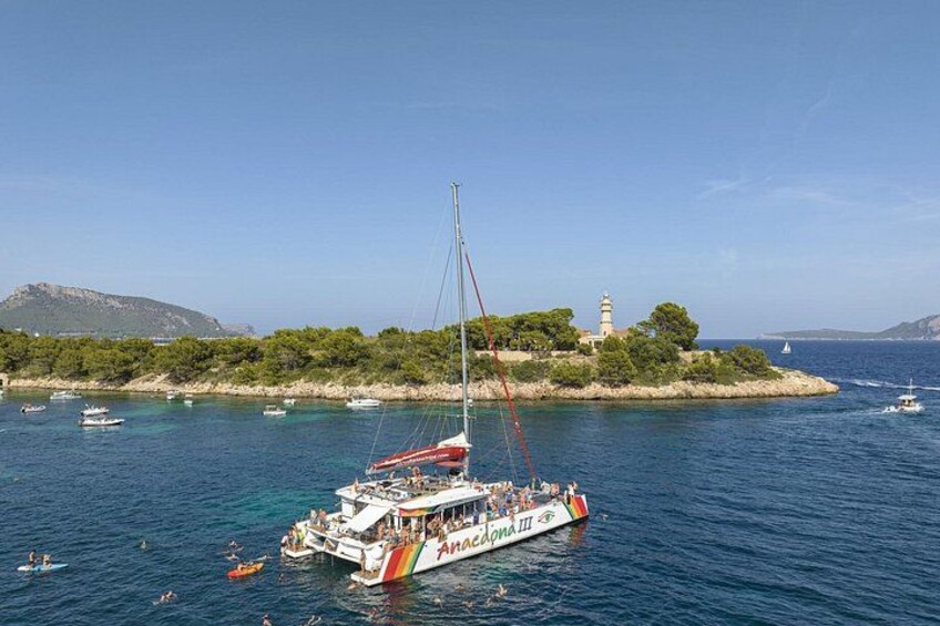 Une scène côtière avec un voilier nommé « Azzurro III » ancré près d’un phare et d’une île rocheuse. 2