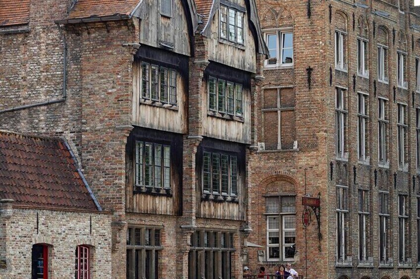 A historic building with multiple windows and a red door. 3