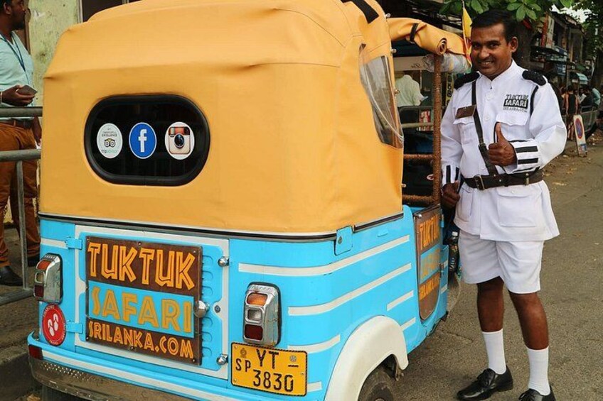 A tuk-tuk with a blue and yellow color scheme, a license plate, and a Facebook and Instagram logo sticker. 4