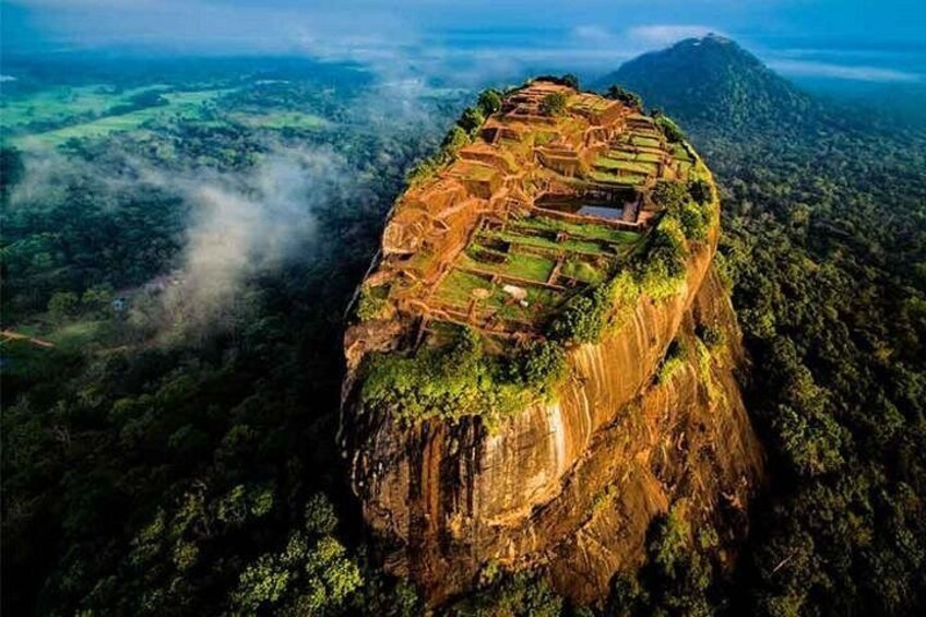 A terraced landscape on a cliff, surrounded by dense forest. 1